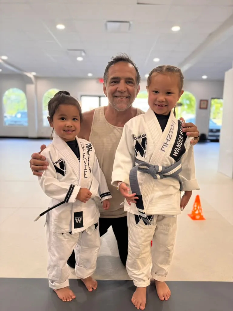 Professor Wander Braga with two Little Braga students in Cornelius